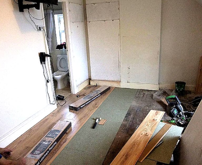 a wood installation process, with a lot of wood flooring
