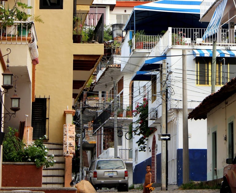 a street scene of Puerto Vallarta with boy and toy