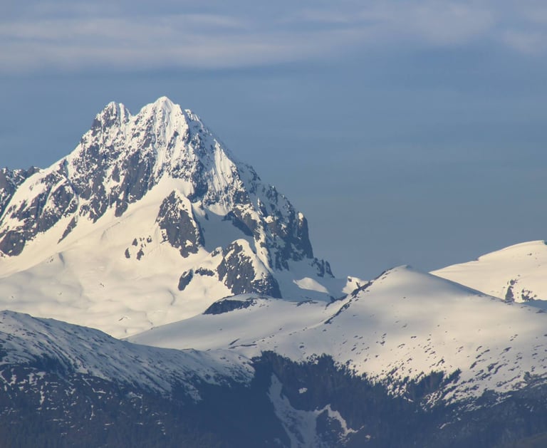 a mountain range with snow covered mountains in the background