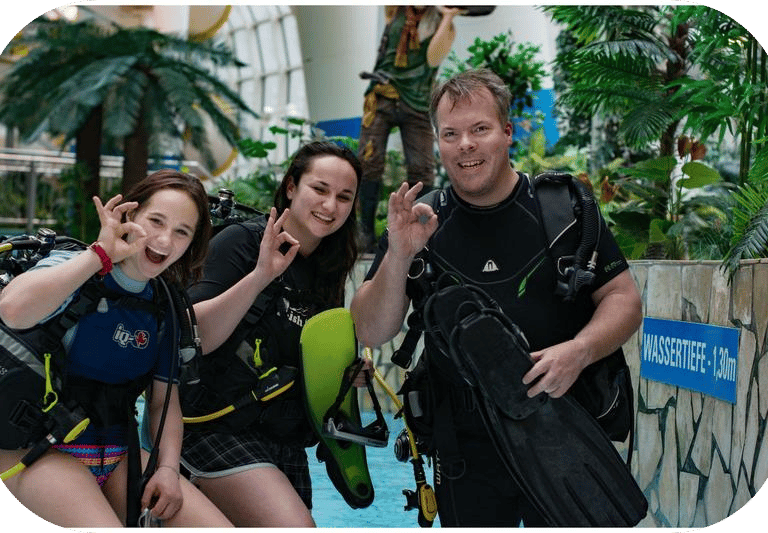 a group of people standing around a pool