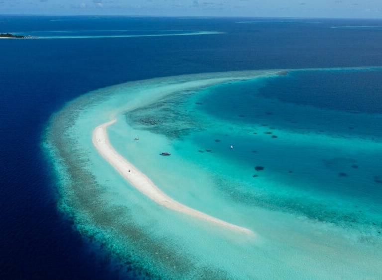 a small island with a small island in the middle of the ocean