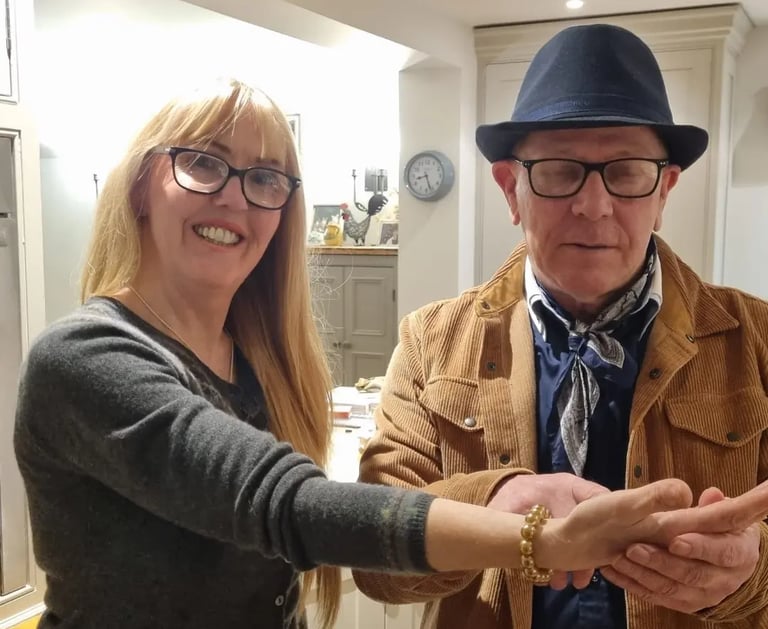 Rob Hamilton reading the palm of a female client