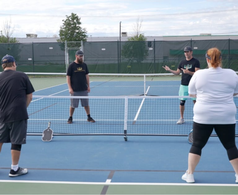 The Pickleball Experience Pro Coaches- Teaching a pickleball lesson