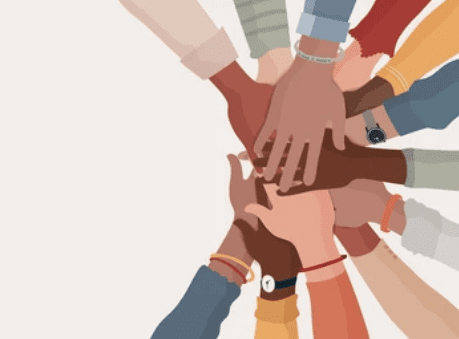 a group of people holding hands together in a circle