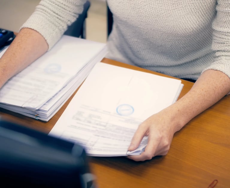 a woman sitting at a desk with a calculator