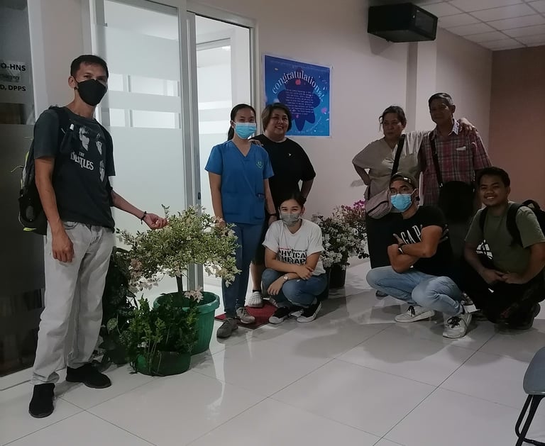 a group of people standing in a room with masks on