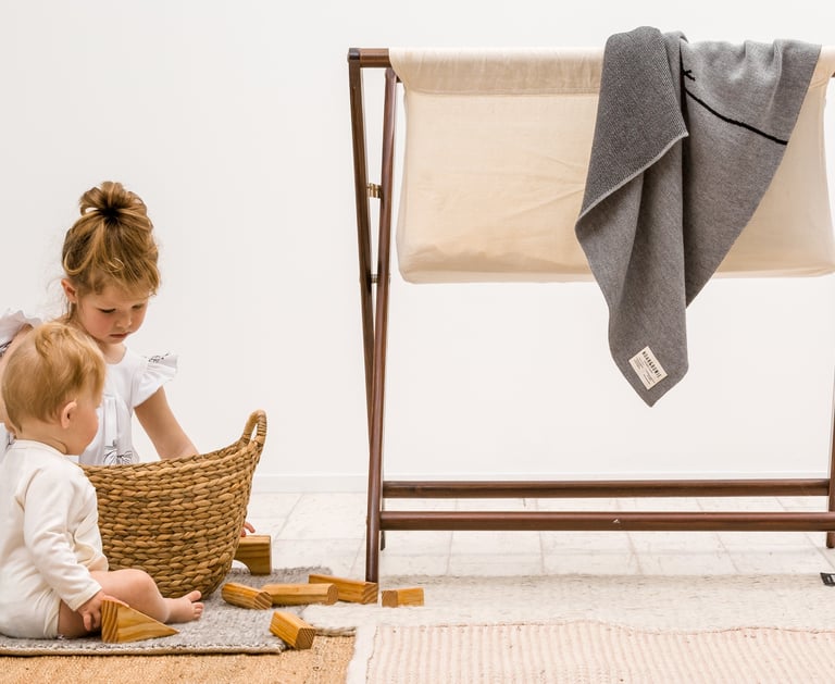 Product photography - a baby girl and boy playing with a basket and blocks