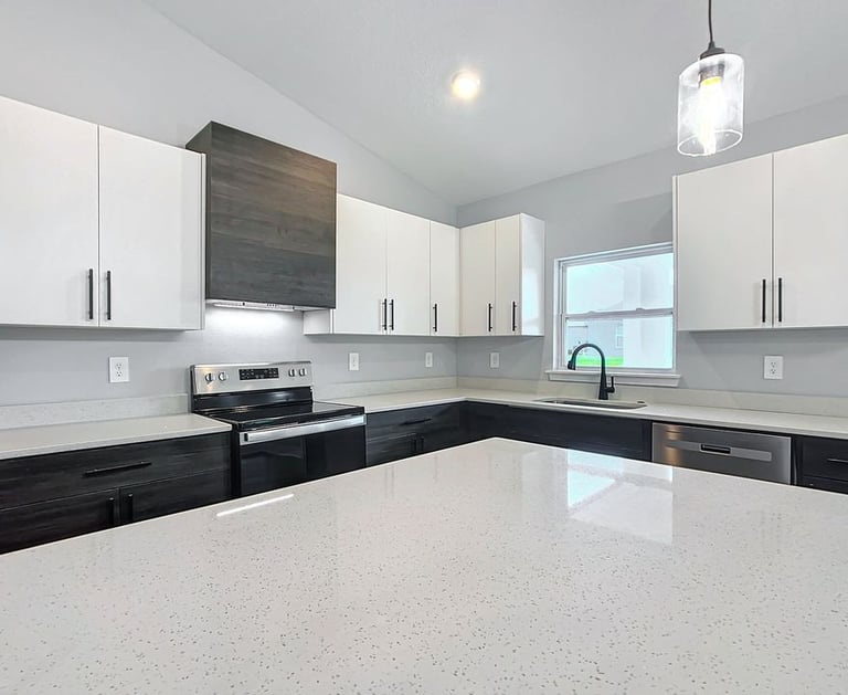 Modern kitchen renovation with quartz countertops, shaker cabinets, and recessed lighting installed 