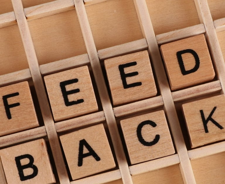 a wooden block with the words feedback on it