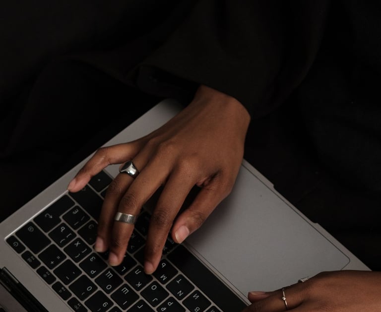 a woman's hands on a laptop computer