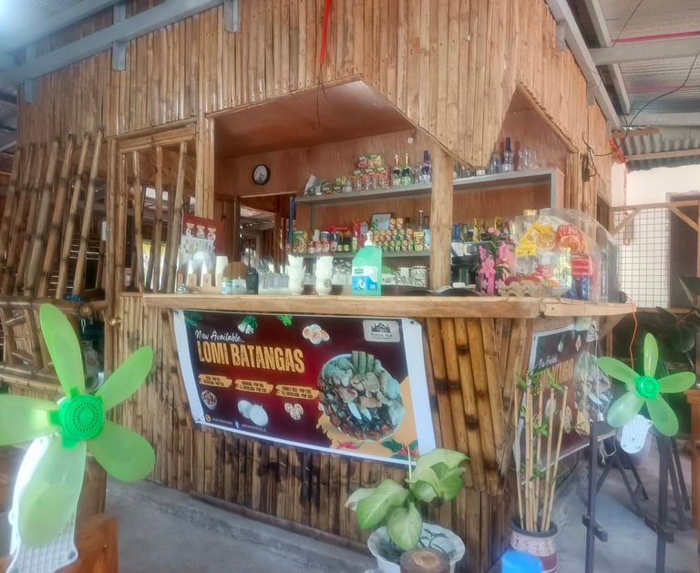 Rustic bamboo restaurant counter in the Philippines advertising authentic Lomi Batangas noodle soup.