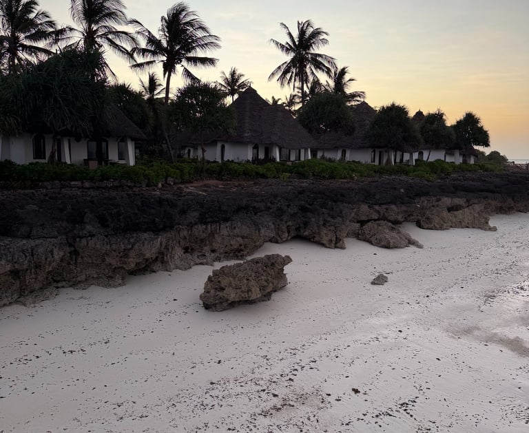 Relaxing beach escape in Zanzibar with lounge chairs and turquoise water planned by ThetravelingTrendie