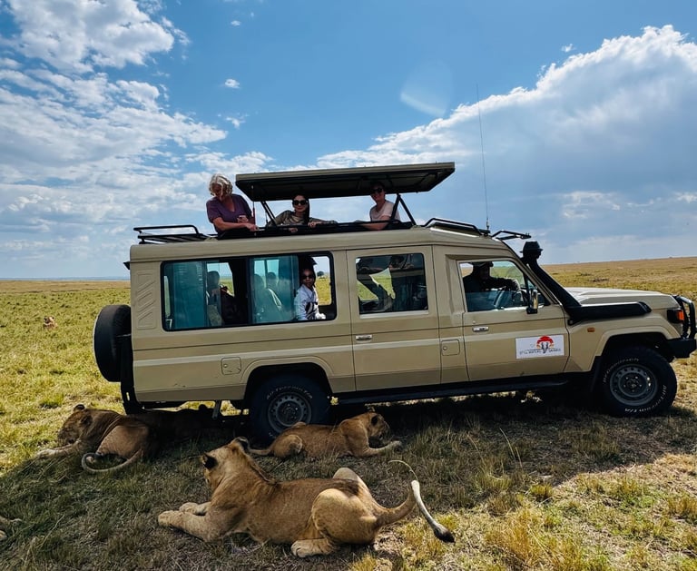 Luxury group safari jeep with lions on game drive in Tanzania, curated by ThetravelingTrendie.