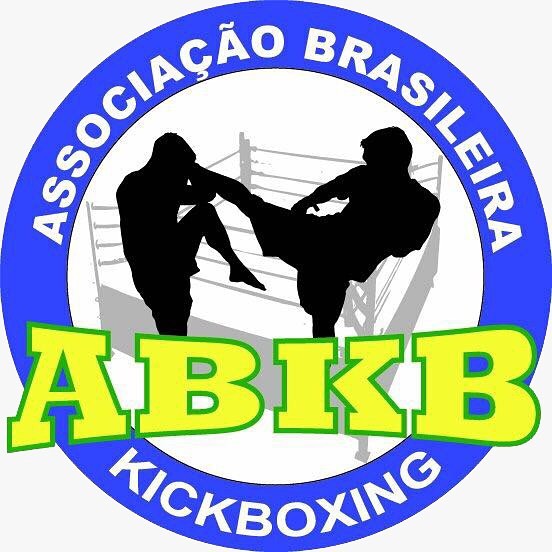 a man kicking a kickbox in front of a logo