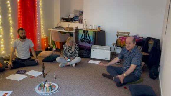 People sitting in a circle during a spiritual meditation session with Eugen Mirtz