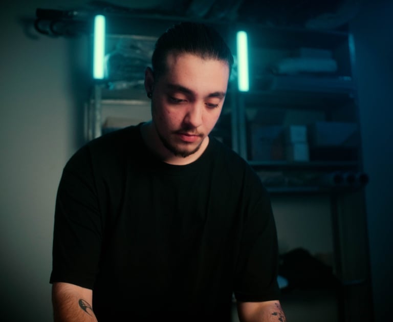 a man with tattoos on his arm and a black shirt