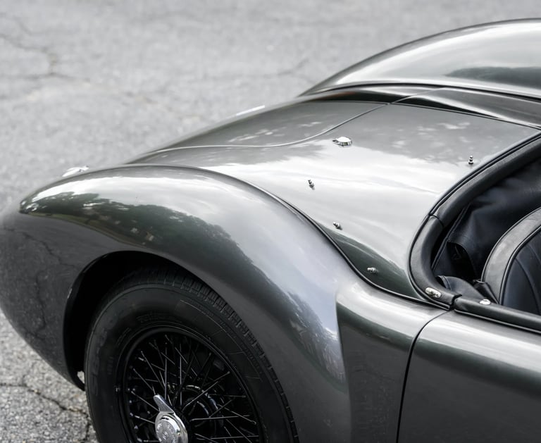 A close up rear view of a silver and black 1958 MG MGA Roadster