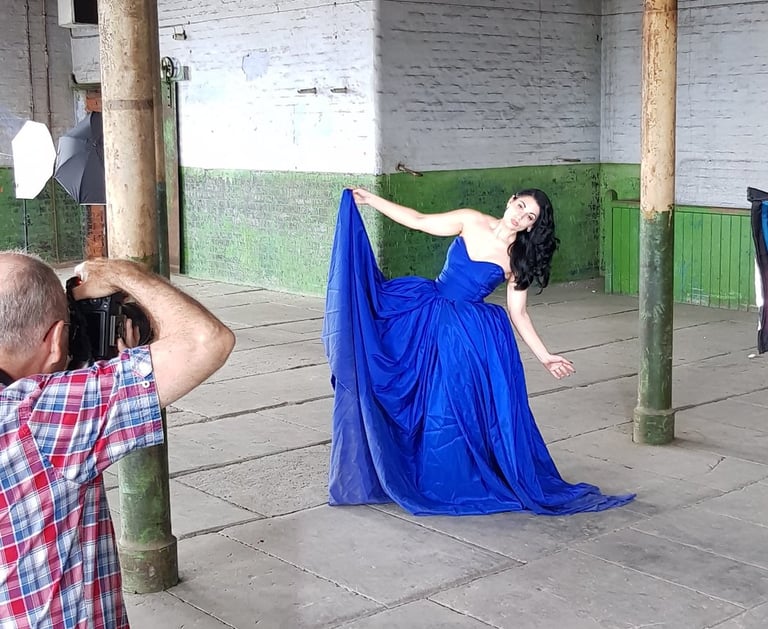 Photographer taking photographs of model in the Stone Room at Atlas Studios for their portfolio.