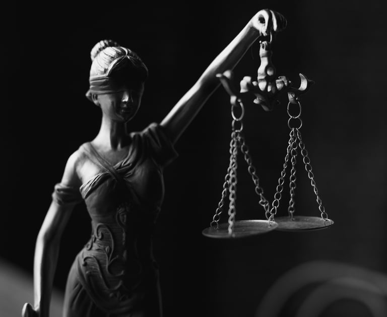 Law image (a figurine of a blindfolded holding a weighing scale)