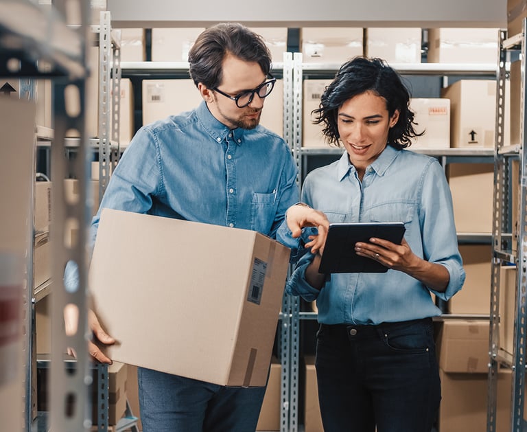 a man and woman in a warehouse setting
