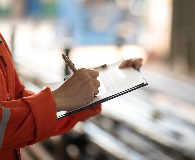 a person in a red jacket and a pen and a pen
