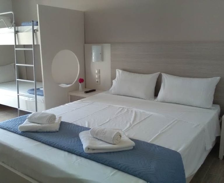 a room with a double bed and bunk beds