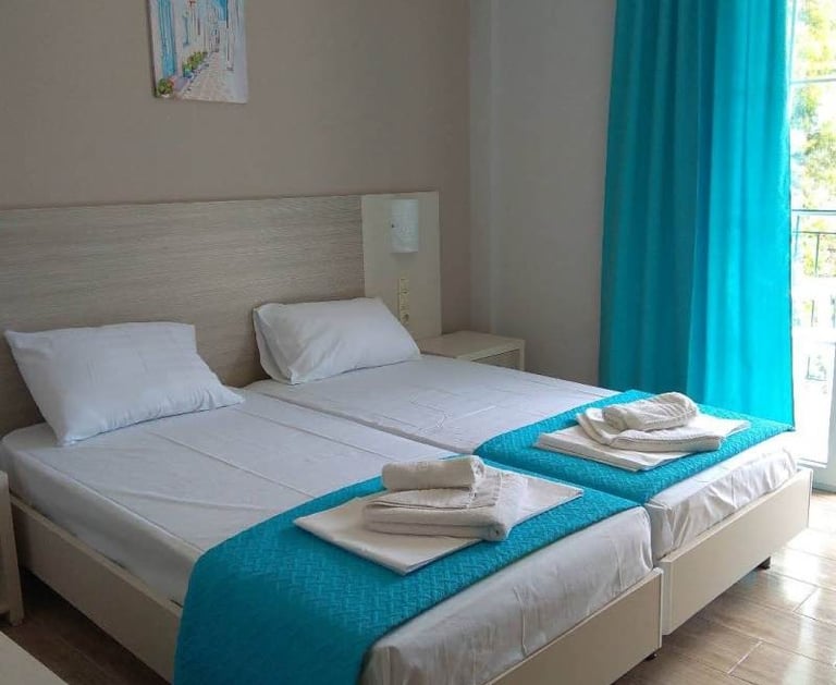 a bedroom with two beds and a balcony