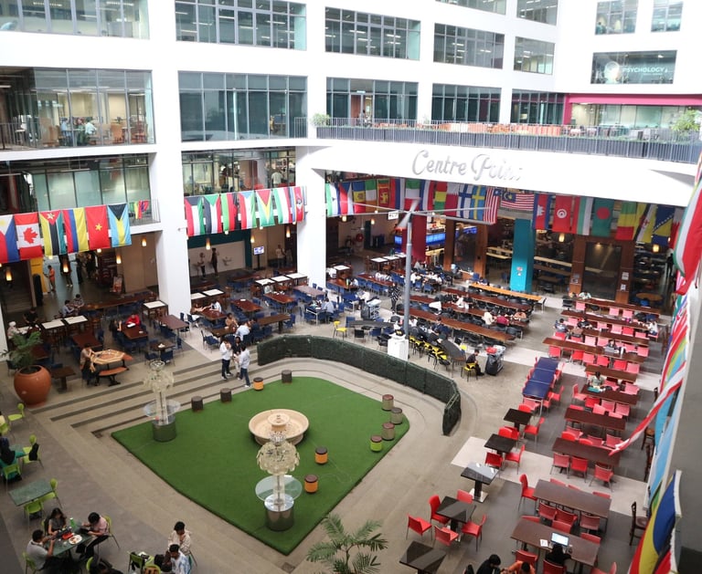 APU Main Hall with many international flags