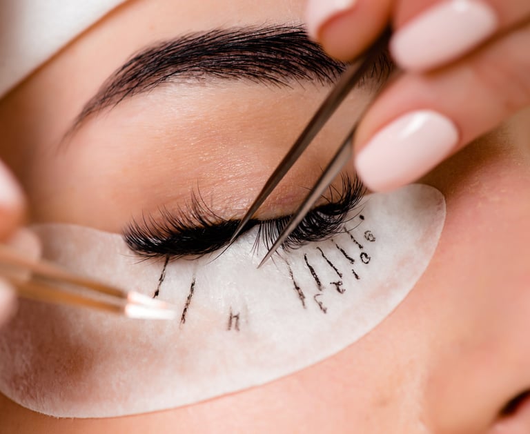 eyelash extension professional applying eyelash extensions, client has lash map under eye