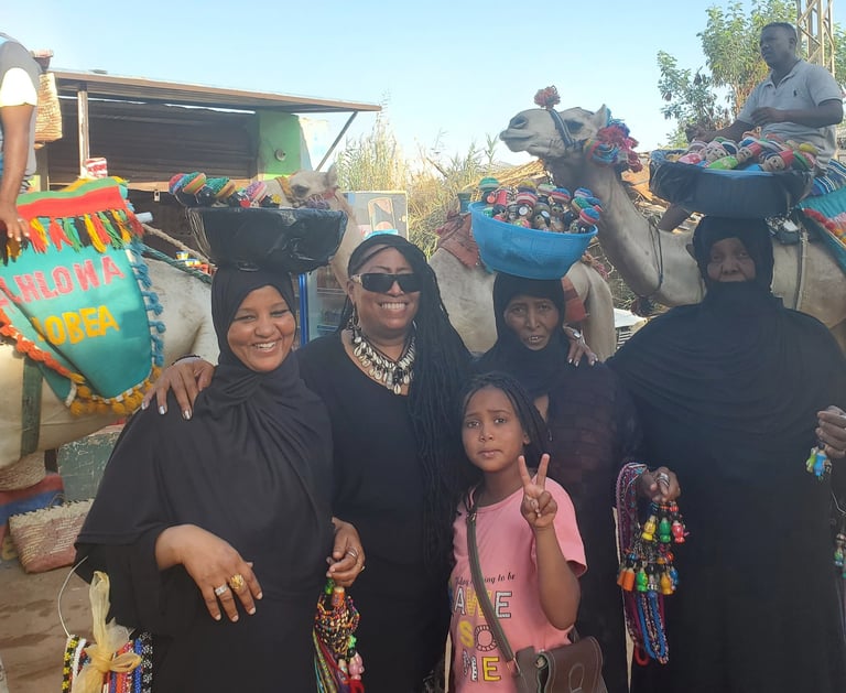 Davida Roze in Aswan egypt with Nubia women and men on camels