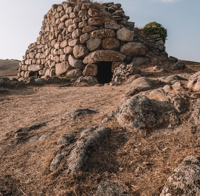 a stone wall with a small stone structure