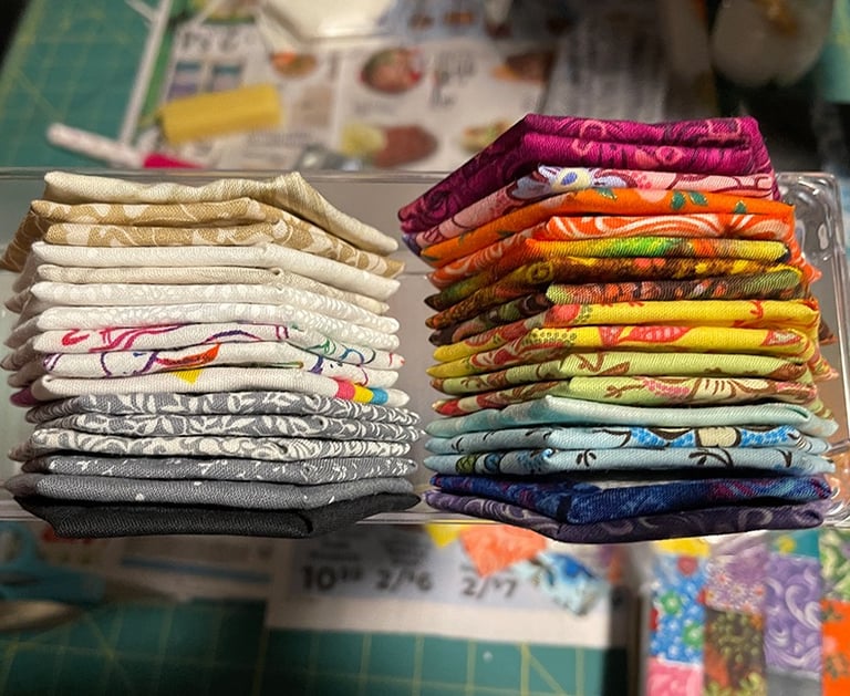 a bunch of sewn cloth hexagons stacked on top of each other