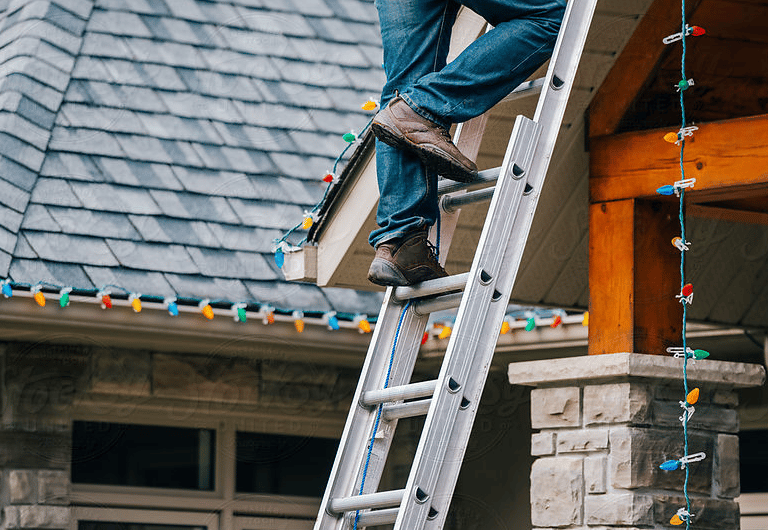 installing christmas lights on a ladder