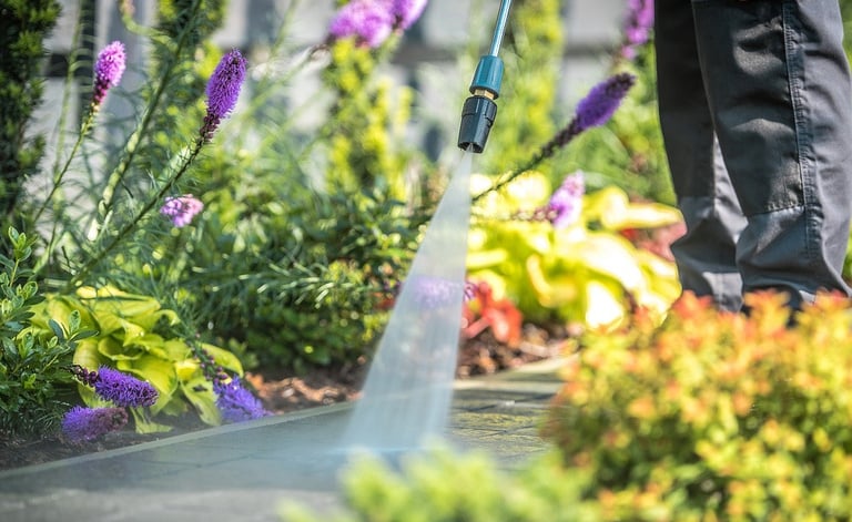 Man pressure washing residential walkway