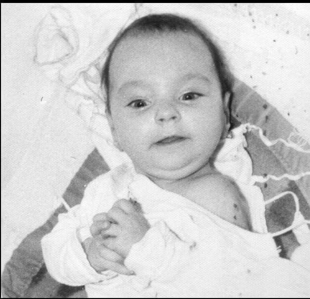 a baby looking up towards the camera