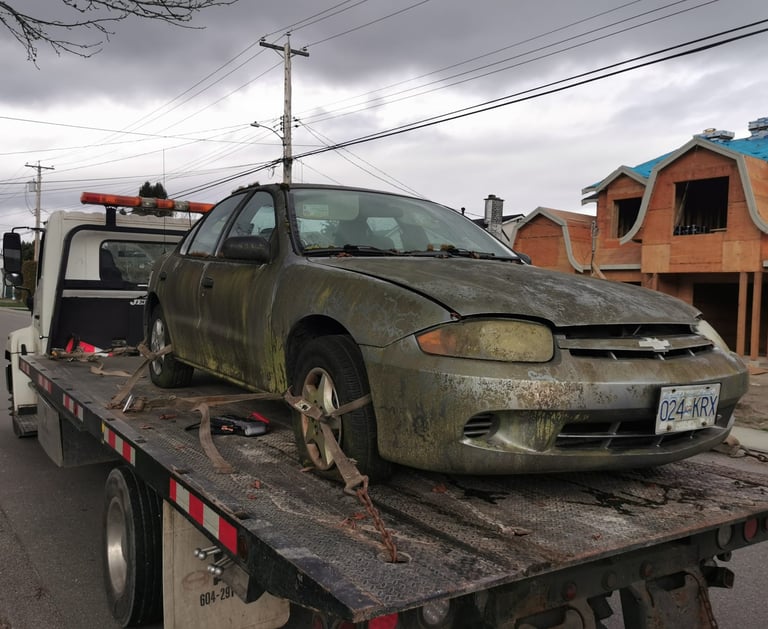A junk car being towed away from a clients residence in Surrey