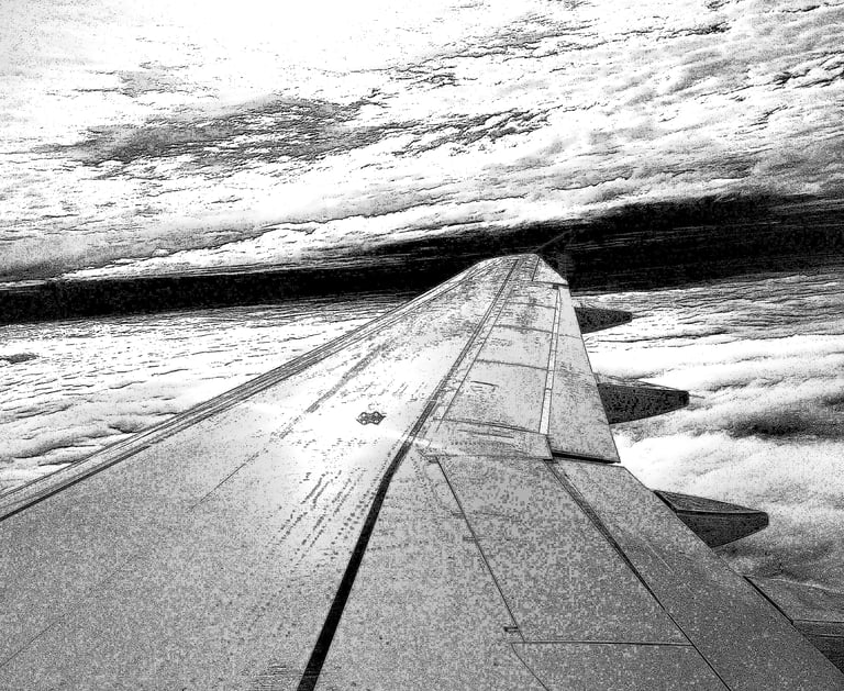 View of an airplane wing over clouds, captured in high-contrast black and white, depicting a journey through the sky.