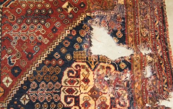 moth holed damaged rug