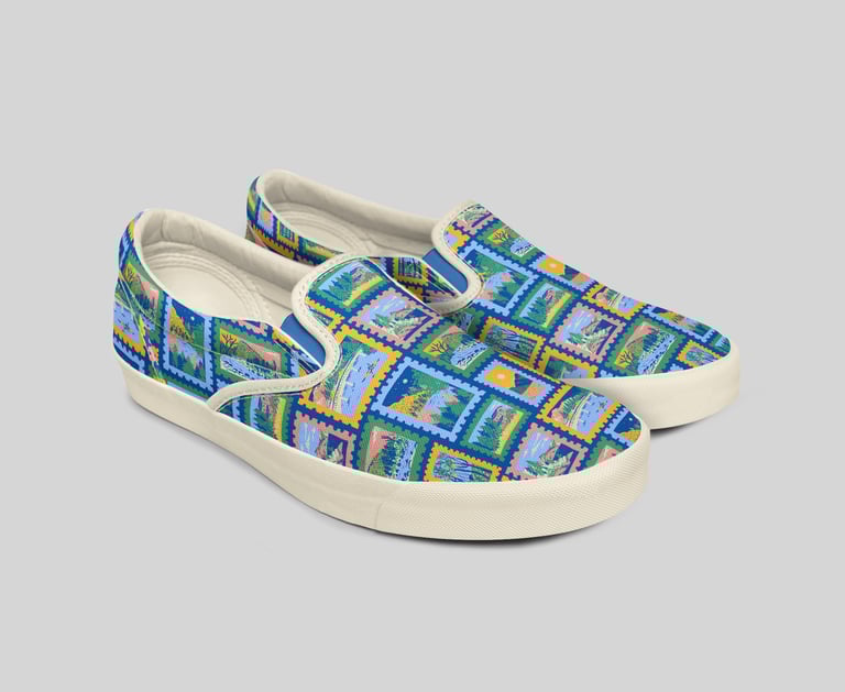 a pair of shoes with a colorful pattern of mountains on the top