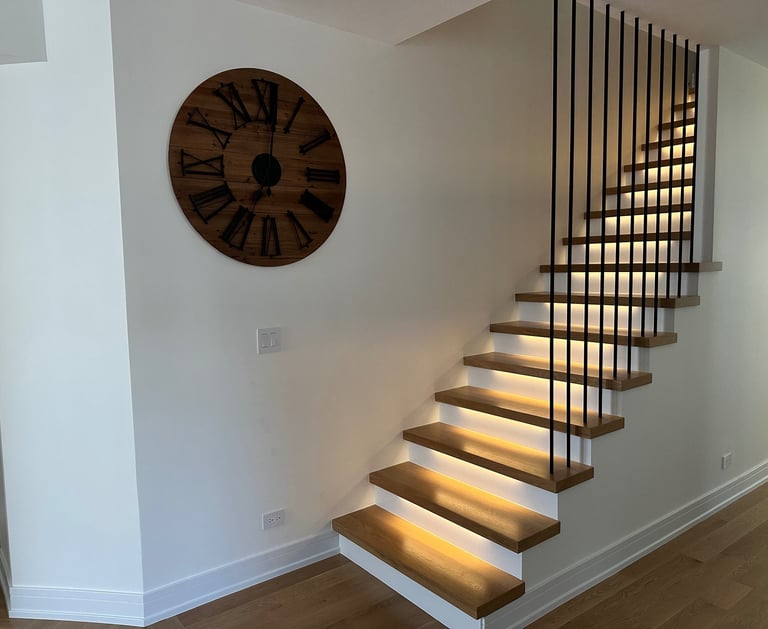 Modern floating oak staircase renovation with LED under-lighting and custom black metal railings