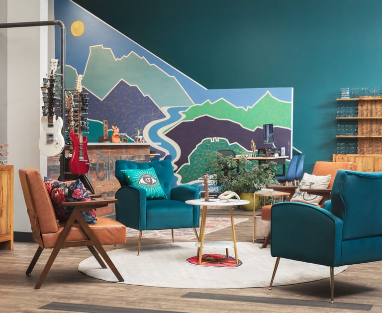Interior of Edge Optics Fort Collins location, with the mountain mural, stylish seating, and guitars