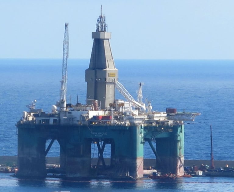 a large oil rig with a large tower in the middle of the picture