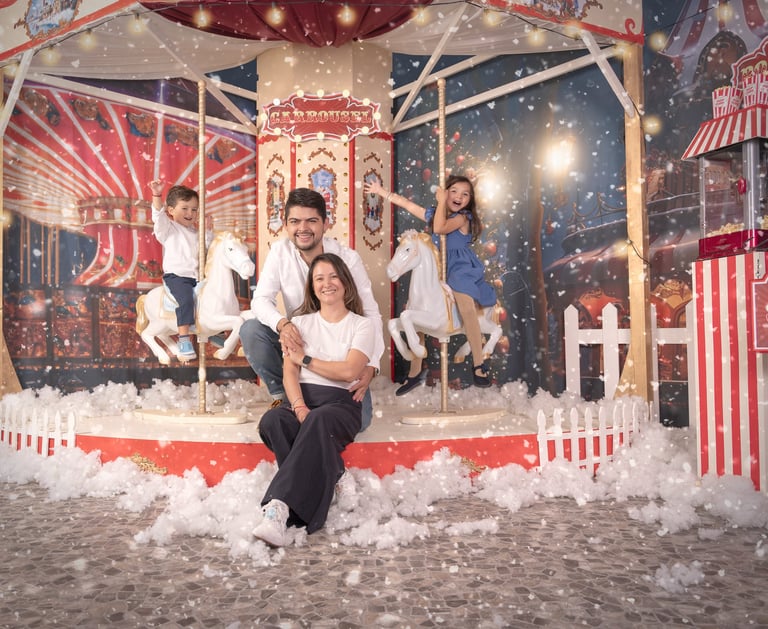 a family posing for a photo in front of a carousel