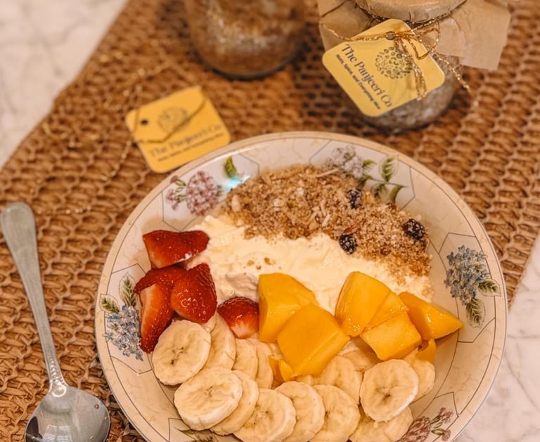 A plate of fresh fruit served with creamy yogurt, a healthy pairing for Panjeeri.