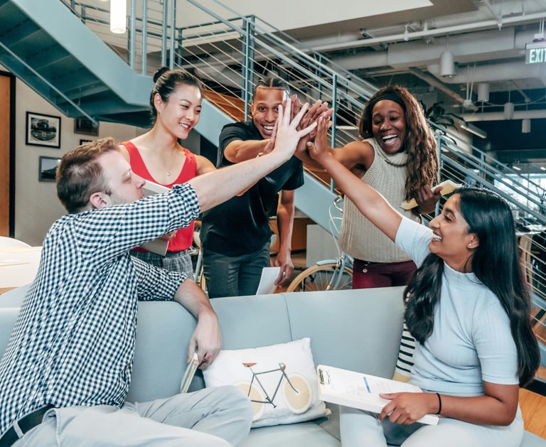 a group of people standing around a couch
