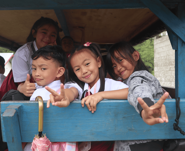 a group of children in school uniforms posing for a picture