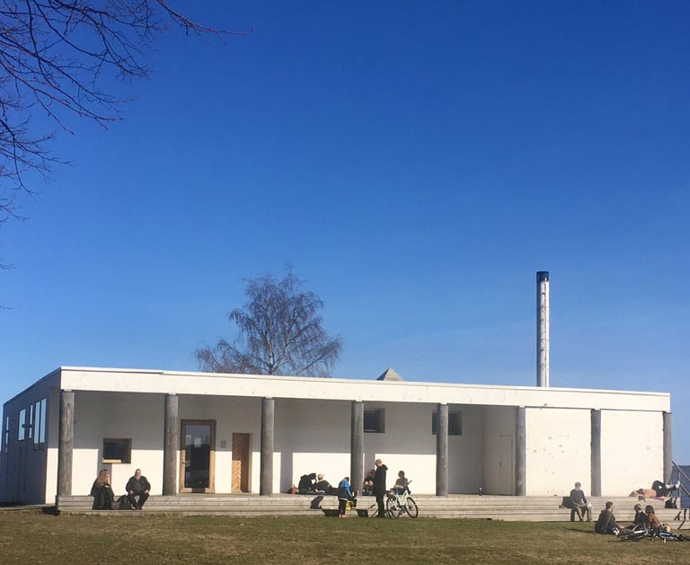 a group of people sitting on a lawn