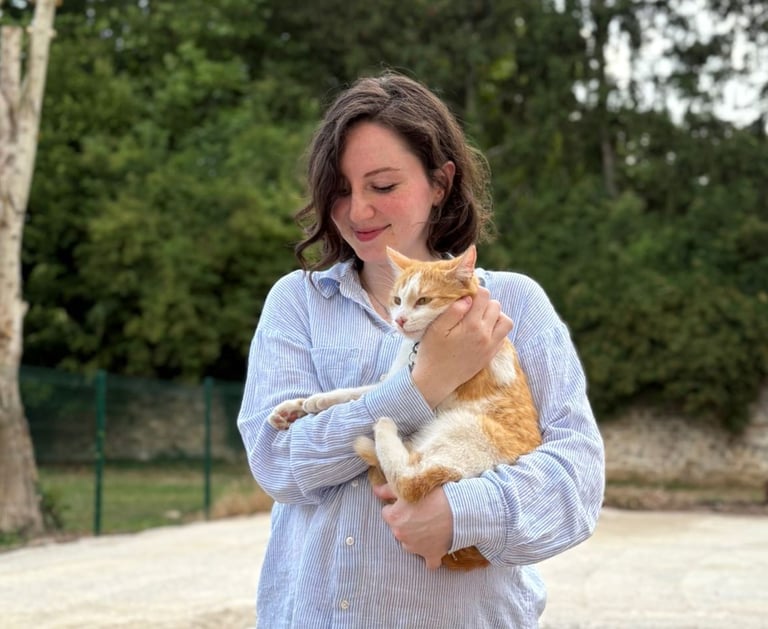 a woman holding a cat in her arms