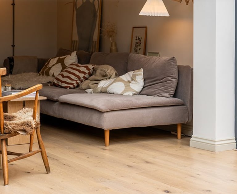 a dog laying on a couch in a living room