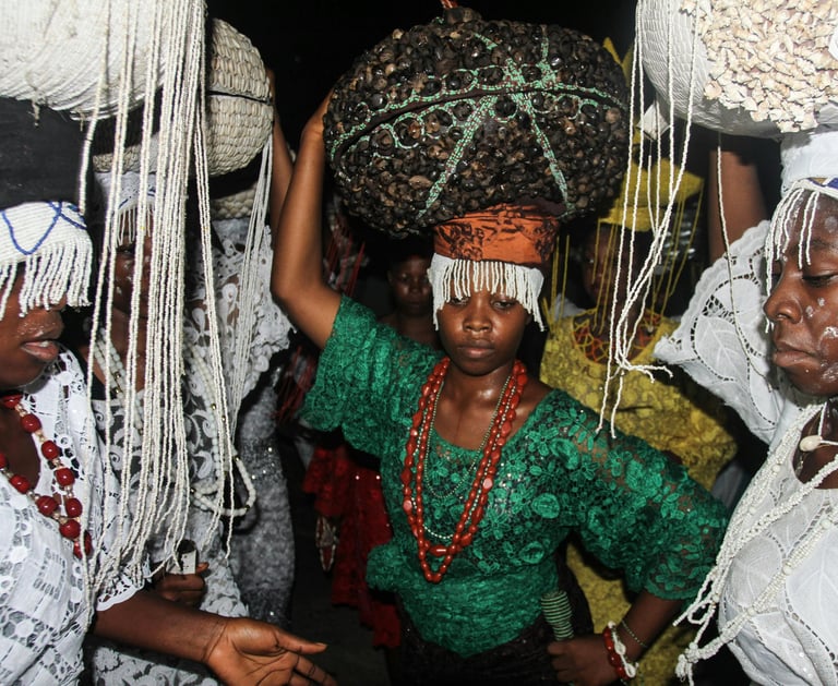 a woman in a green dress with a large basket on her head